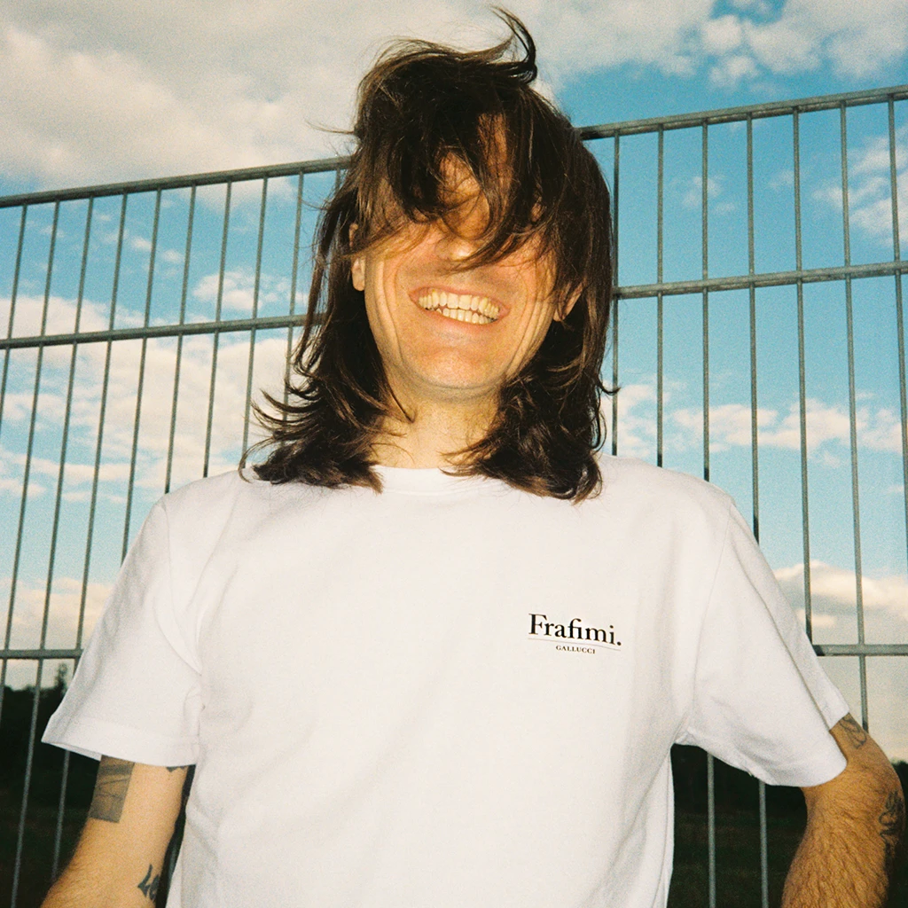 Model wears the FRAFIMI GALLUCCI Understatement t-shirt in white – Frankfurter Lifegeil Collectiv 3000